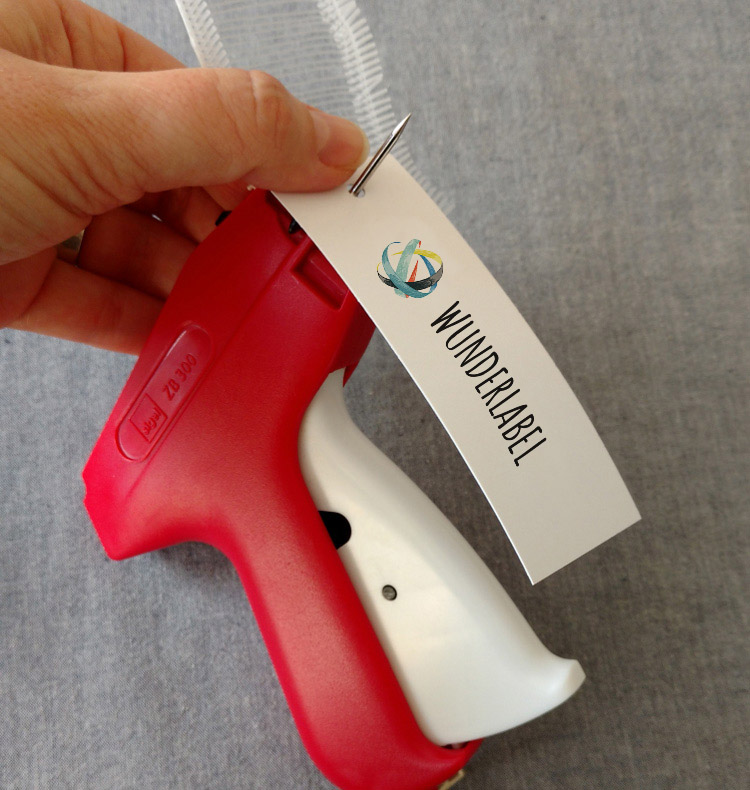First step of attaching a hang tag with a tagging gun tagging gun with hang tag